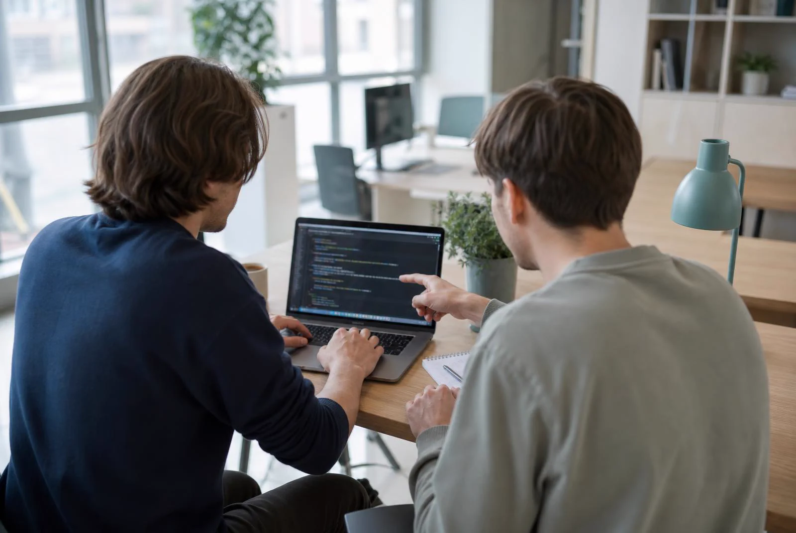 Twee developers werken samen aan code